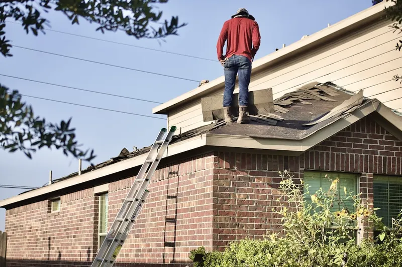 Professional roofer working on a residential roof in Nokesville